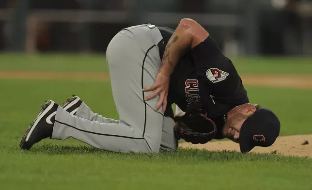 Cleveland Guardians' pitcher Ben Lively lays on the field after being hit by a ball during the second inning of a baseball game against the Chicago White Sox, Tuesday, Sept. 10, 2024, in Chicago. (AP Photo/Melissa Tamez)