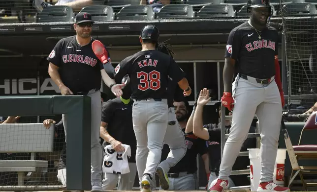 Cleveland Guardians manager Stephen Vogt, left, celebrates with Steven Kwan (38) at the dugout after scoring on a Lane Thomas 2 RBI single during the first inning of a baseball game against the Chicago White Sox in Chicago, Wednesday, Sept. 11, 2024. (AP Photo/Paul Beaty)