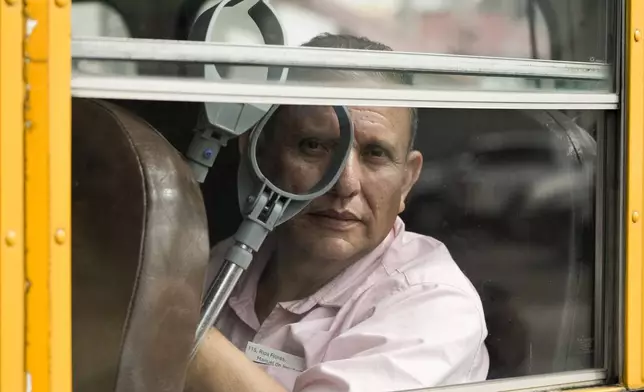 A Nicaraguan citizen rides on a bus after being released from a Nicaraguan jail and landing at the airport in Guatemala City, Thursday, Sept. 5, 2024. (AP Photo/Moises Castillo)