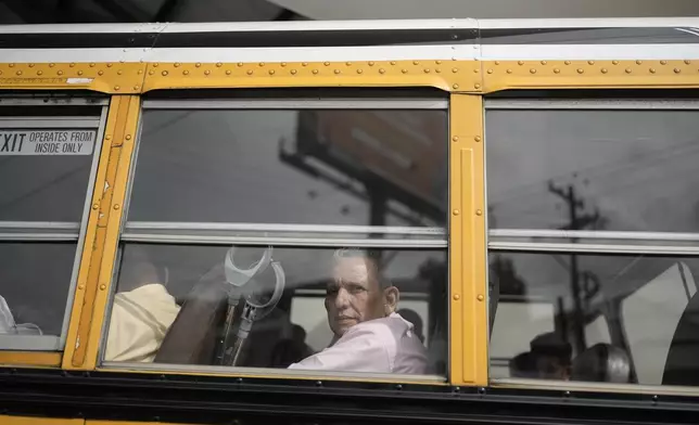 Manuel Rios peers from a bus after being released from a Nicaraguan jail and landing at the airport in Guatemala City, Thursday, Sept. 5, 2024. (AP Photo/Moises Castillo)