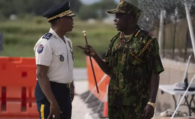 The commander of the Multinational Security Support (MSS) mission Godfrey Otunge, right, and the Haitian National Police general director Rameau Normil chat as they await the arrival of U.S. Secretary of State Antony Blinken in Port-au-Prince, Haiti, Thursday, Sept. 5, 2024. (Roberto Schmidt/Pool photo via AP)