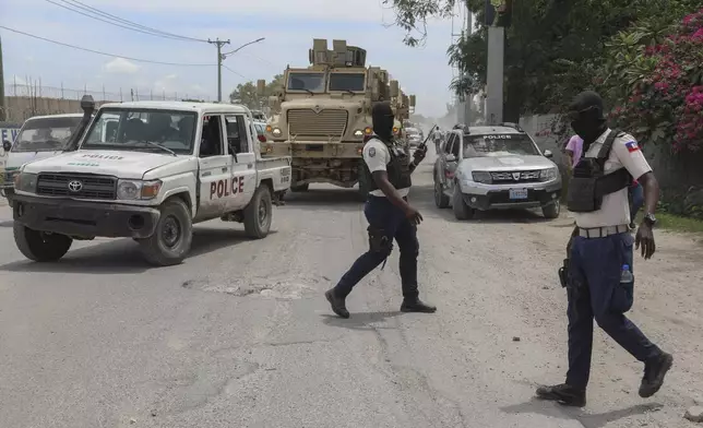 Police officers patrol a street near the airport in Port-au-Prince, Haiti, Thursday, Sept. 5, 2024. (AP Photo/Odelyn Joseph)