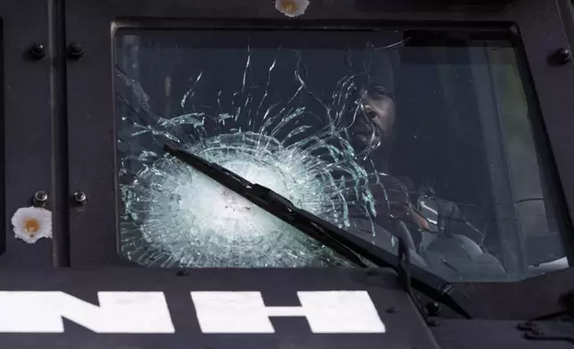 A Haitian national police officer sits inside an armored vehicle donated by the U.S. government as he awaits the arrival of U.S. Secretary of State Antony Blinken, in Port-au-Prince, Haiti, Thursday, Sept. 5, 2024. (Roberto Schmidt/Pool photo via AP)