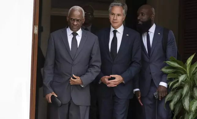 U.S. Secretary of State Antony Blinken, center, and Haitian Transitional Presidential Council Coordinator Edgard Leblanc Fils, left, arrive to speak to the press at the U.S. Chief of Mission Residence in Port-au-Prince, Haiti, Thursday, Sept. 5, 2024. (Roberto Schmidt/Pool photo via AP)