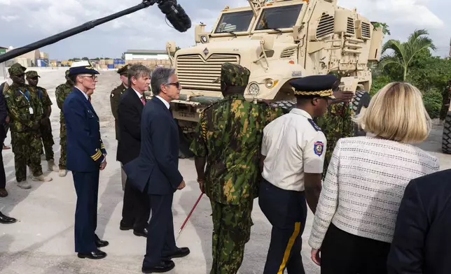 Commander of the Multinational Security Support Mission Commander Godfrey Otunge, third from right, shows U.S. Secretary of State Antony Blinken, fourth from right, armored vehicles the U.S. government donated at the MSS base in Port-au-Prince, Haiti, Thursday, Sept. 5, 2024. (Roberto Schmidt/Pool photo via AP)