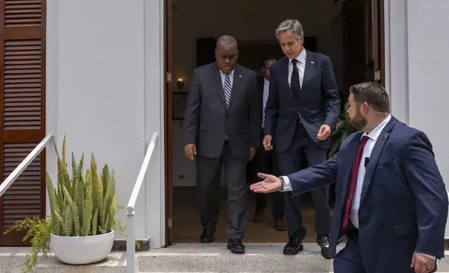 U.S. Secretary of State Antony Blinken, top right, and Haitian Prime Minister Garry Conille arrive to speak to the press at the U.S. Chief of Mission Residence in Port-au-Prince, Haiti, Thursday, Sept. 5, 2024. (Roberto Schmidt/Pool photo via AP)