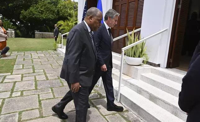 Haitian Prime Minister Garry Conille, front, and U.S. Secretary of State Antony Blinken enter the U.S. Chief of Mission Residence after speaking to the press in Port-au-Prince, Haiti, Thursday, Sept. 5, 2024. (Roberto Schmidt/Pool photo via AP)