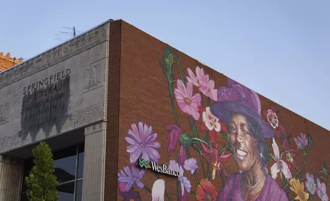 A mural depicting Hattie Moseley, a Springfield Civil Rights activist who was instrumental in battling the segregation of Fulton Elementary School, is painted on the WesBanco building on East Main Street in Springfield, Ohio, Monday, Sept. 16, 2024. (AP Photo/Jessie Wardarski)