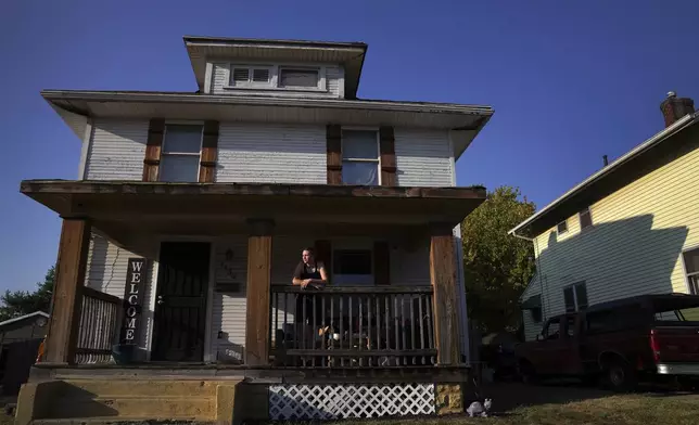 Kassidy Fannon stands on the front porch of her home in Springfield, Ohio, Monday, Sept. 16, 2024. (AP Photo/Jessie Wardarski)