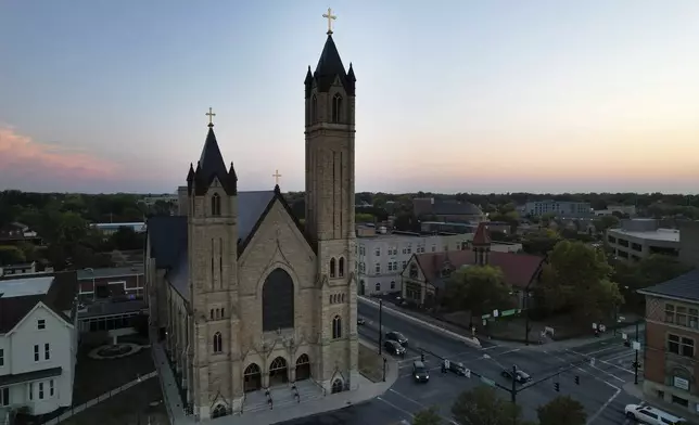 The sun sets behind St. Raphael Catholic church, which holds services in Creole for Haitian immigrants, in Springfield, Ohio, Monday, Sept. 16, 2024. (AP Photo/Jessie Wardarski)