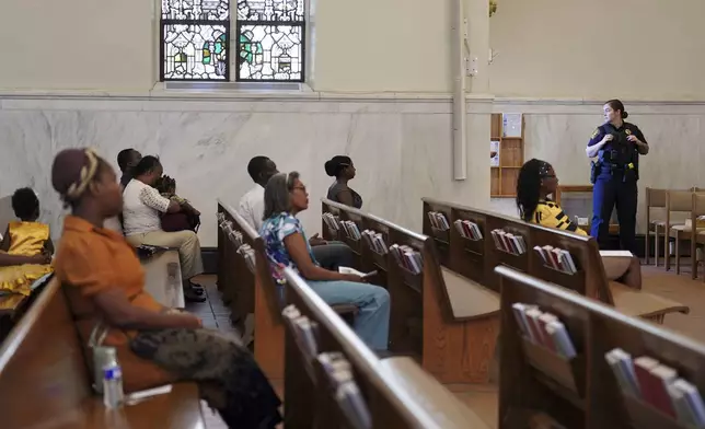 A Springfield police officer stands watch during a service in support of the Haitian community at St. Raphael Catholic church in Springfield, Ohio, Sunday, Sept. 15, 2024. (AP Photo/Jessie Wardarski)