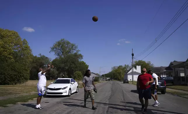 Springfield native Jaheim Almon, left, plays basketball with a group of neighbors in Springfield, Ohio, Monday, Sept. 16, 2024. (AP Photo/Jessie Wardarski)