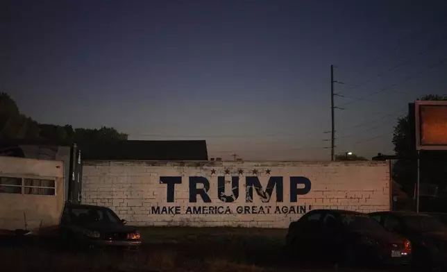 A political advertisement for Republican presidential nominee and former President Donald Trump is painted on the side of an automotive business in Springfield, Ohio, Monday, Sept. 16, 2024. (AP Photo/Jessie Wardarski)