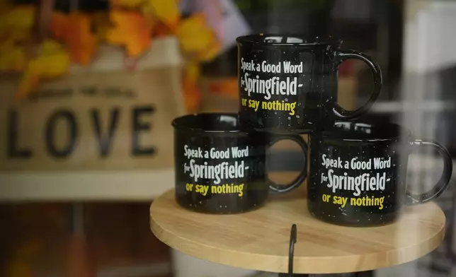 Mugs that read "Speak a Good Word for Springfield or say nothing" are displayed in the Champion City Guide &amp; Supply shop window on Tuesday, Sept. 17, 2024, in Springfield, Ohio. (AP Photo/Carolyn Kaster)