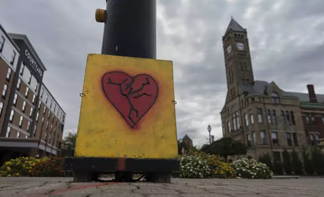 An image of a broken heart is fixed across the street from City Hall with the Heritage Center of Clark County, right, Tuesday, Sept. 17, 2024, in Springfield, Ohio. (AP Photo/Carolyn Kaster)