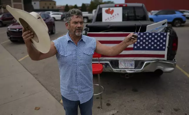 Cowboy David Graham, of Newark, Ohio, calls out messages of support across the street from City Hall, Tuesday, Sept. 17, 2024, in Springfield, Ohio. (AP Photo/Carolyn Kaster)