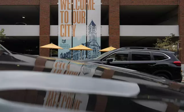 A banner with the images of the Heritage Center of Clark County and "Welcome To Our City," hangs along North Fountain Ave. Tuesday, Sept. 17, 2024, in Springfield, Ohio. (AP Photo/Carolyn Kaster)