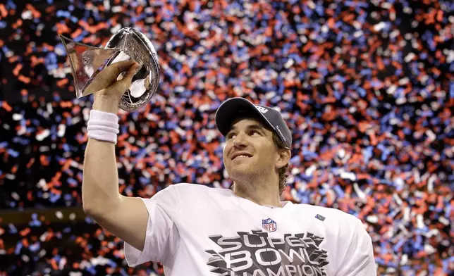 FILE - New York Giants quarterback Eli Manning holds up the Vince Lombardi Trophy while celebrating his team's 21-17 win over the New England Patriots in the NFL Super Bowl XLVI football game, Sunday, Feb. 5, 2012, in Indianapolis. (AP Photo/David J. Phillip, File0