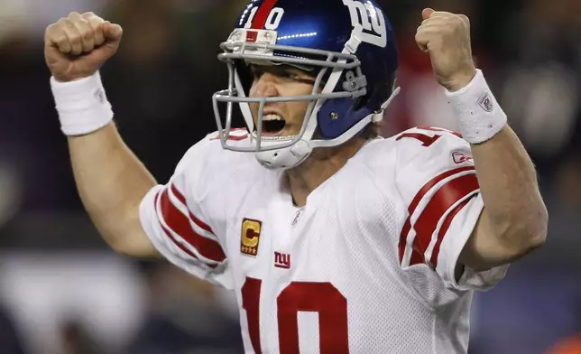 FILE - New York Giants quarterback Eli Manning celebrates his touchdown pass to tight end Jake Ballard in the last minute of an NFL football game against the New England Patriots in Foxborough, Mass., Sunday, Nov. 6, 2011. (AP Photo/Charles Krupa, File)