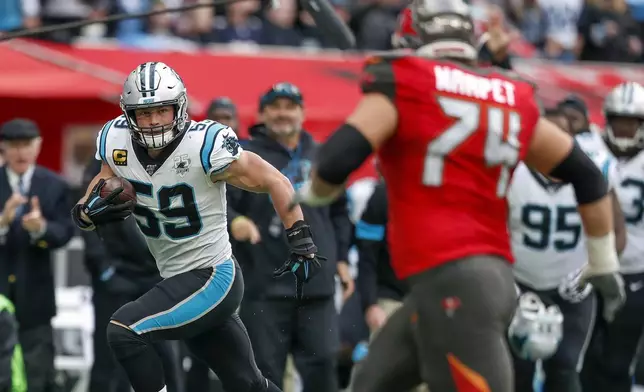 FILE - Carolina Panthers middle linebacker Luke Kuechly (59) returns a fumble recovery against the Tampa Bay Buccaneers during the third quarter of an NFL football game, Sunday, Oct. 13, 2019, at Tottenham Hotspur Stadium in London. (AP Photo/Alastair Grant, File)