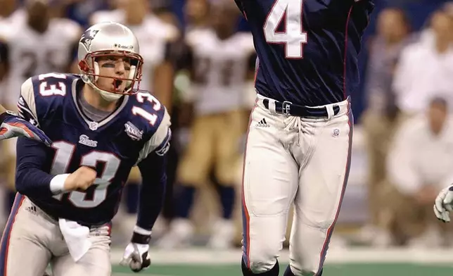 FILE - New England Patriots kicker Adam Vinatieri (4), joined by teammate Ken Walter who held the ball, celebrates his 48-yard game-winning field goal in the final seconds of Super Bowl XXXVI against the St. Louis Rams, Feb. 3, 2002, in New Orleans. (AP Photo/Amy Sancetta, File)