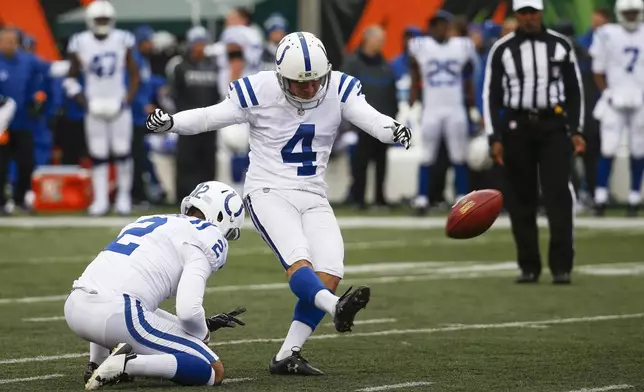 FILE - Indianapolis Colts kicker Adam Vinatieri (4) kicks a field goal from the hold of Rigoberto Sanchez (2) during the first half of an NFL football game against the Cincinnati Bengals, Sunday, Oct. 29, 2017, in Cincinnati. (AP Photo/Frank Victores, File)