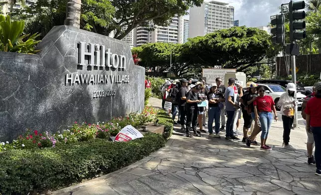 Hotel workers march outside the Hilton Hawaiian Village resort after going on strike on Tuesday, Sept. 24, 2024, in Honolulu. (AP Photo/Jennifer Sinco Kelleher)