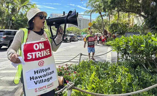 Estella Fontanilla, a housekeeper on strike from the Hilton Hawaiian Village, leads fellow hotel workers in strike chants on Tuesday, Sept. 24, 2024, in Honolulu. (AP Photo/Jennifer Sinco Kelleher)