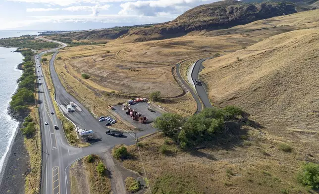 An aerial view shows a truck leaving the Olowalu temporary landfill site after dumping debris from the Lahaina fire on Sunday, July 7, 2024, in Lahaina, Hawaii. (AP Photo/Mengshin Lin)