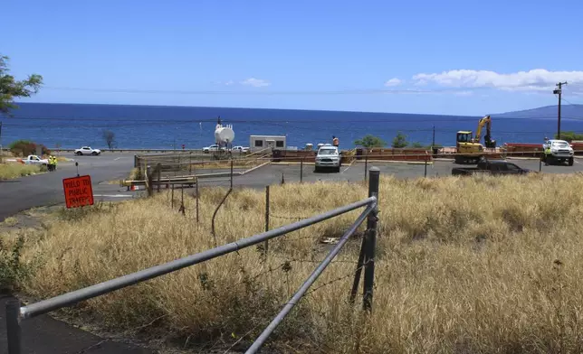 The ocean can be seen from the entrance to a dump site in Lahaina, Hawaii on Thursday, July 18, 2024. (AP Photo/Jennifer Sinco Kelleher)