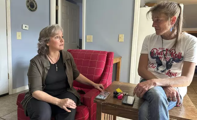 Heidi Wright, right, who is experiencing homelessness and must leave her state-funded motel room by Sept. 28, 2024, talks to Jen Armbrister, an outreach case manager for the Good Samaritan Haven in Barre, Vt., on Wednesday, Sept. 18, 2024. (AP Photo/Lisa Rathke)