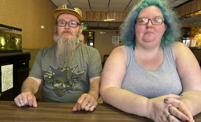 Bruce and Nova Jewett, who are experiencing homelessness, sit at the Hilltop Inn in Berlin, Vt., on Wednesday, Sept. 18, 2024, where they have been living and will have to leave by Oct. 1, 2024. (AP Photo/Lisa Rathke)