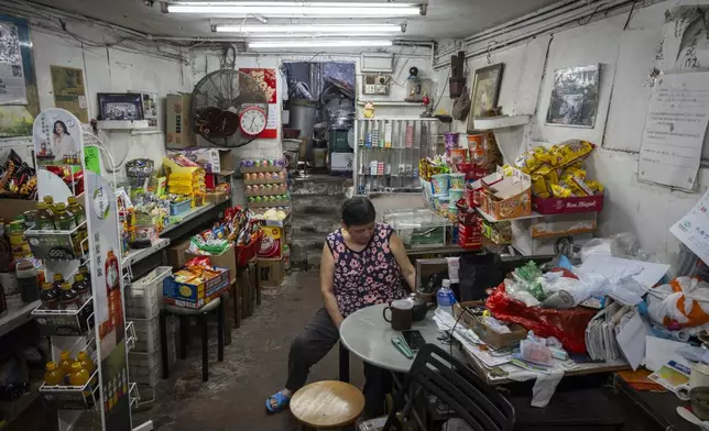 A villager tends her store at the Cha Kwo Ling village in east Kowloon, Hong Kong, Sunday, Aug. 25, 2024. (AP Photo/Chan Long Hei)