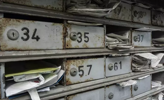 Letterboxes stuffed with mails are seen at the Cha Kwo Ling village in east Kowloon, Hong Kong, Sunday, Aug. 25, 2024. (AP Photo/Chan Long Hei)