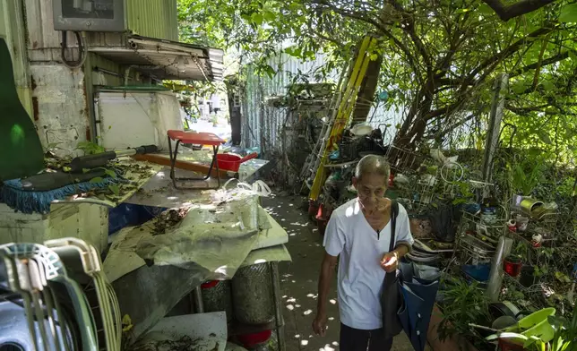 A villager walks through the Cha Kwo Ling village in east Kowloon, Hong Kong, Sunday, Aug. 25, 2024. (AP Photo/Chan Long Hei)