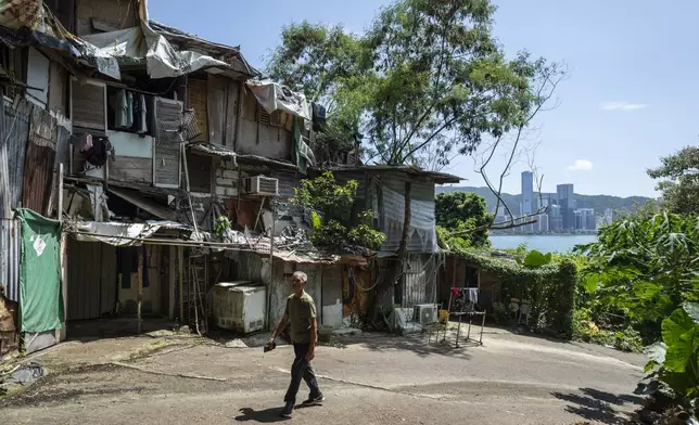 A villager walks through the Cha Kwo Ling village in east Kowloon, Hong Kong, Sunday, Aug. 25, 2024. (AP Photo/Chan Long Hei)