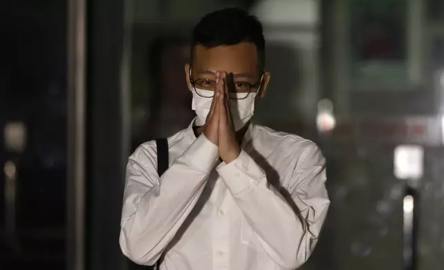 Patrick Lam, the former acting editor-in-chief of Hong Kong's now shuttered pro-democracy news outlet Stand News gestures to the gathered media as he leaves the Wanchai District Court after the final sentencing of Stand News sedition case in Wan Chai district court in Hong Kong on Thursday, Sept. 26, 2024. (AP Photo/May James)