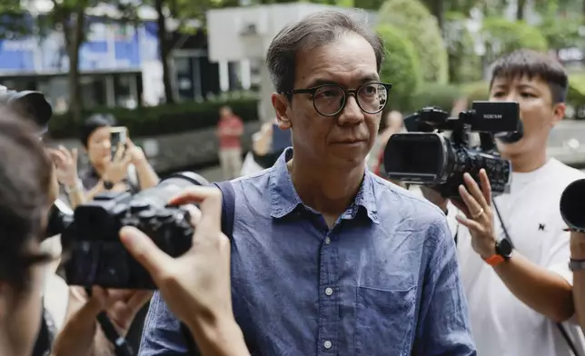 Chung Pui-kuen, the former chief editor of Hong Kong's now shuttered pro-democracy news outlet Stand News, walks past waiting media as he arrives at the Wanchai District Court ahead of the final sentencing of Stand News sedition case in Wan Chai district court in Hong Kong on Thursday, Sept. 26, 2024. (AP Photo/May James)