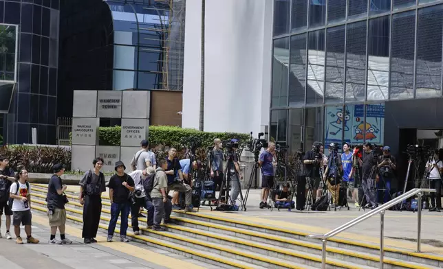 Media line up outside the District Court in Wan Chai, Hong Kong, ahead of a sentencing hearing for two former Stand News editors convicted of sedition, Thursday, Sept. 26, 2024. (AP Photo/May James)