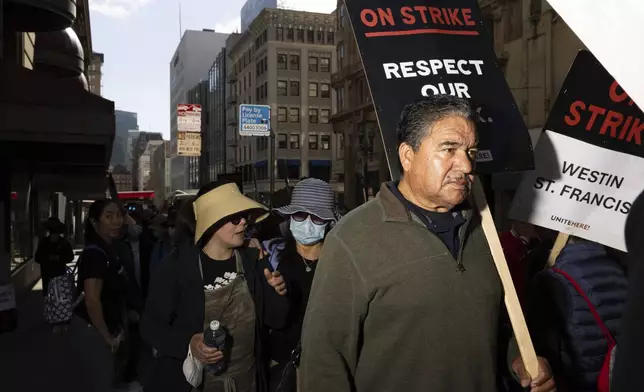 Hotel workers picket outside the Westin St. Francis Monday, Sept. 2, 2024, in San Francisco. (AP Photo/Benjamin Fanjoy)