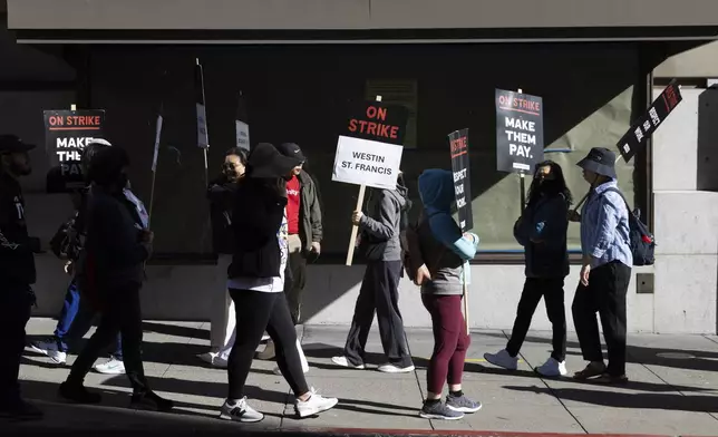 Hotel workers picket outside the Westin St. Francis Monday, Sept. 2, 2024, in San Francisco. (AP Photo/Benjamin Fanjoy)