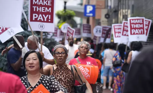 Union members from Local 26, representing workers in the hospitality industries of Massachusetts, picket outside the Hyatt Regency Boston, Wednesday, July 17, 2024, in Boston. (AP Photo/Charles Krupa)