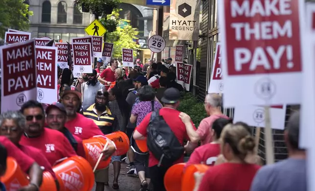 Union members from Local 26, representing workers in the hospitality industries of Massachusetts, picket outside the Hyatt Regency Boston, Wednesday, July 17, 2024, in Boston. (AP Photo/Charles Krupa)