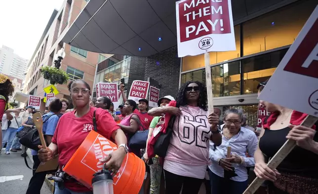 Union members from Local 26, representing workers in the hospitality industries of Massachusetts, picket outside the Hyatt Regency Boston, Wednesday, July 17, 2024, in Boston. (AP Photo/Charles Krupa)