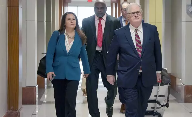 Retired Houston Police Department officer Gerald Goines, center, and his defense team arrive at 482nd District Court for his trial on two felony murder charges in the January 2019 deaths of Dennis Tuttle and Rhogena Nicholas, Monday, Sept. 9, 2024 at Harris County Criminal Courthouse in Houston. (Yi-Chin Lee/Houston Chronicle via AP)