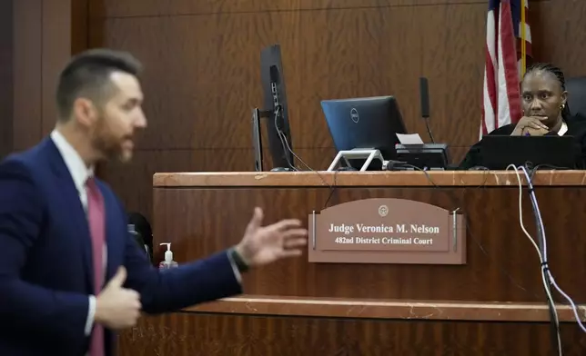 Judge Veronica M. Nelson listens to prosecutors Keaton Forcht delivering opening statement for the trial of retired Houston Police Department officer Gerald Goines at the 482nd District Court Monday, Sept. 9, 2024, at the Harris County Criminal Courthouse in Houston. Goines was on trial for two felony murder charges in the January 2019 deaths of Dennis Tuttle and Rhogena Nicholas. (Yi-Chin Lee/Houston Chronicle via AP)