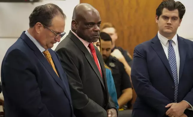 Retired Houston Police Department officer Gerald Goines, center, listens to the prosecutor reading his two felony murder charges in the January 2019 deaths of Dennis Tuttle and Rhogena Nicholas, Monday, Sept. 9, 2024, at Harris County Criminal Courthouse in Houston. (Yi-Chin Lee/Houston Chronicle via AP)