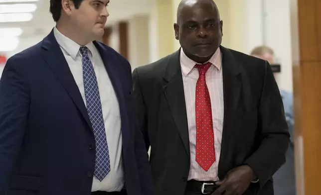 Retired Houston Police Department officer Gerald Goines, right, goes back to the 482nd District Court after a brief break Monday, Sept. 9, 2024, at the Harris County Criminal Courthouse in Houston. Goines was on trial on two felony murder charges in the January 2019 deaths of Dennis Tuttle and Rhogena Nicholas. (Yi-Chin Lee/Houston Chronicle via AP)