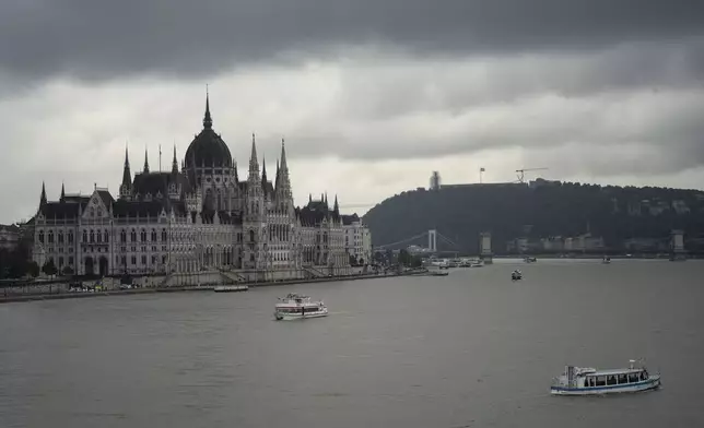 Dark clouds are seen over the Parliament building in Budapest, Hungary, during the flooding of the Danube river on Monday, Sept. 16, 2024. (AP Photo/Denes Erdos)