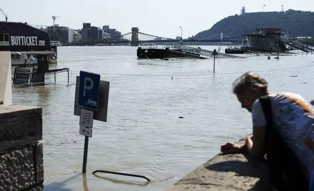 People watch the Danube river as it floods it's banks in central Budapest, Hungary, Thursday, Sept. 19, 2024. (AP Photo/Denes Erdos)